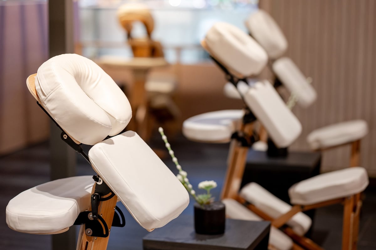 Portable adjustable massage chair set up in a calm treatment room